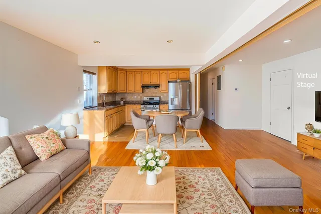 a view of a living room filled with furniture and wooden floor