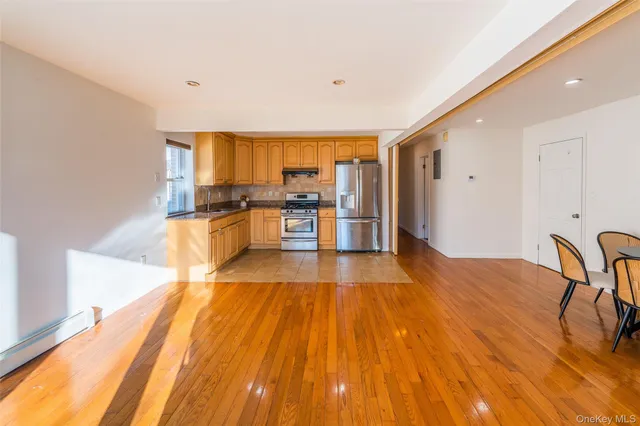 a kitchen with granite countertop stainless steel appliances a refrigerator sink and microwave