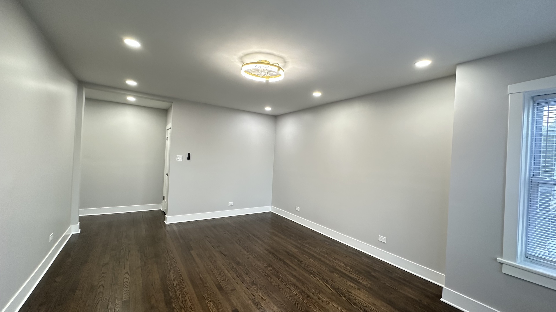 5226 North Bernard Street, Unit 2 Chicago, IL 60625 - Photo 3 of 12 an empty room with wooden floor and windows