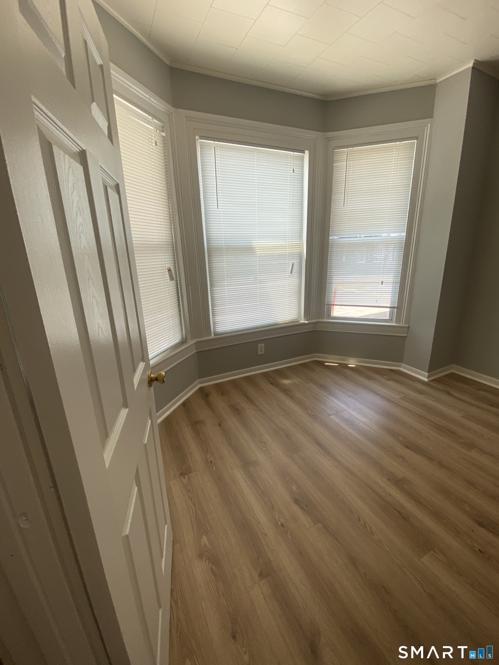 432 East Main Street, Unit 438 Bridgeport, CT 06608 - Photo 3 of 8 a view of an empty room with wooden floor and a window
