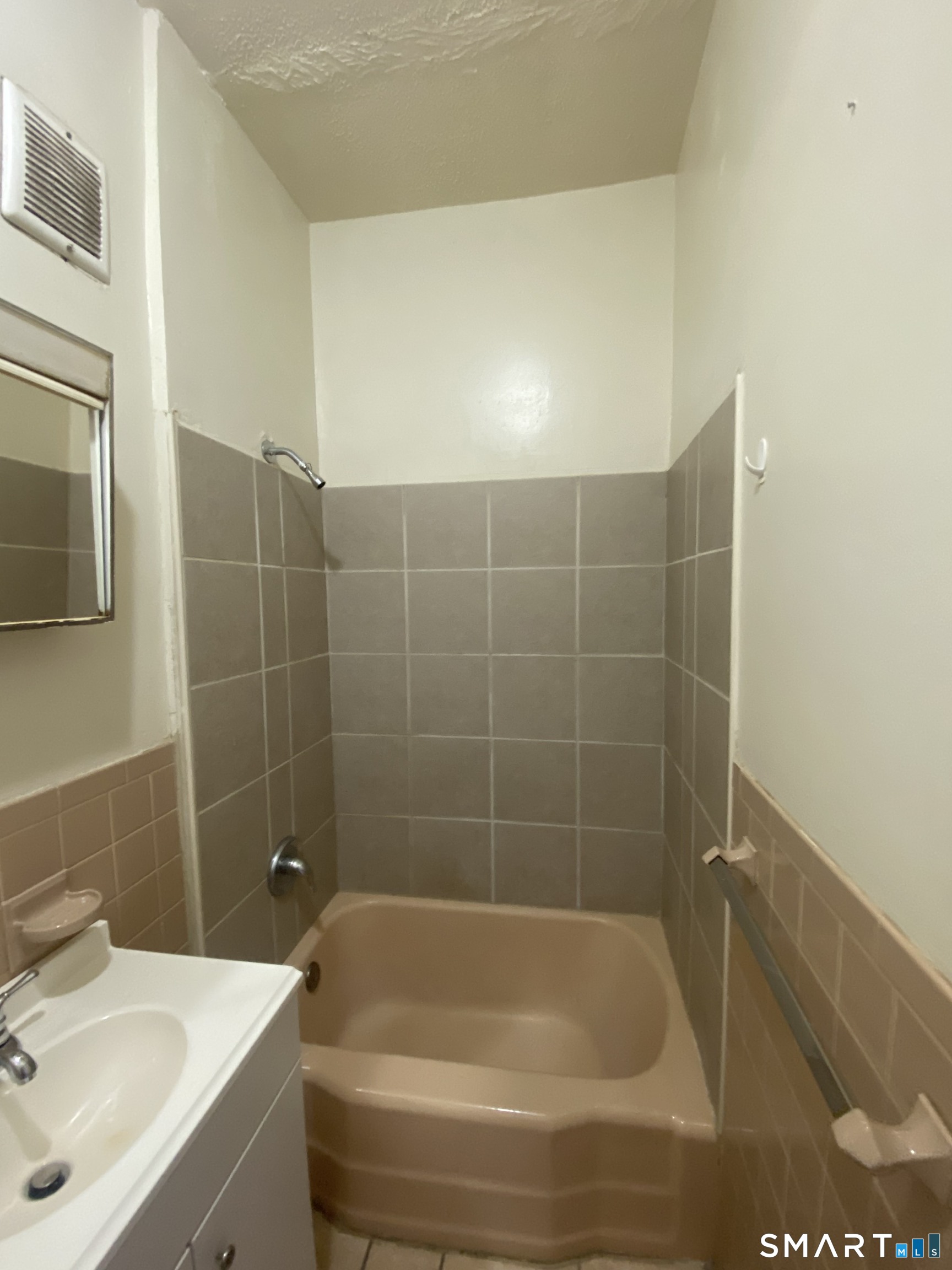 432 East Main Street, Unit 438 Bridgeport, CT 06608 - Photo 5 of 8 a bath tub sitting next to a white sink and vanity
