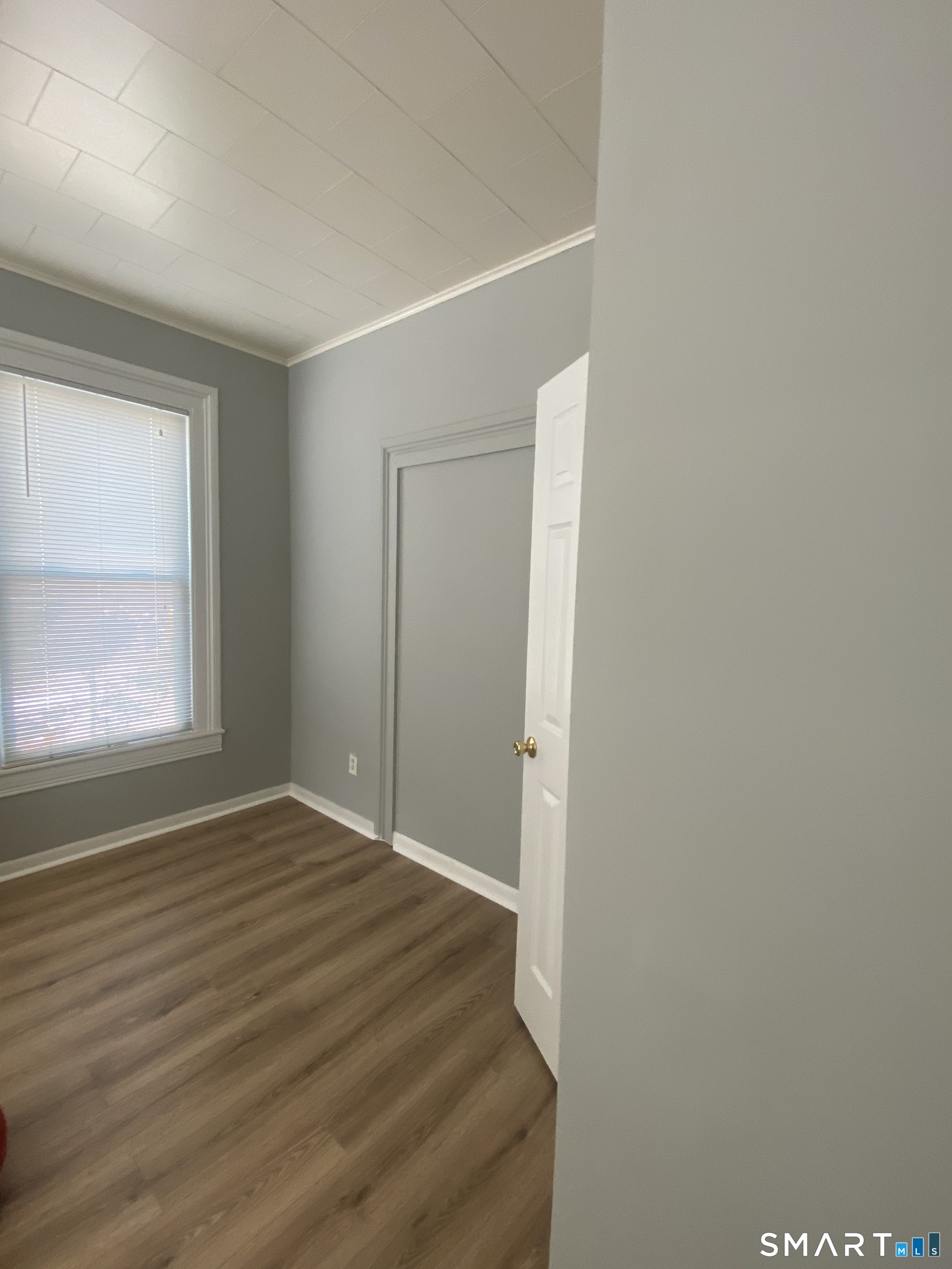 432 East Main Street, Unit 438 Bridgeport, CT 06608 - Photo 8 of 8 a view of an empty room with wooden floor and a window