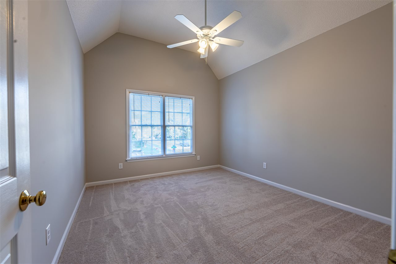 9212 Zermatt Court Raleigh, NC 27617 - Photo 18 of 30 This bedroom features a vaulted ceiling, ceiling fan and new carpet! Bedroom 4