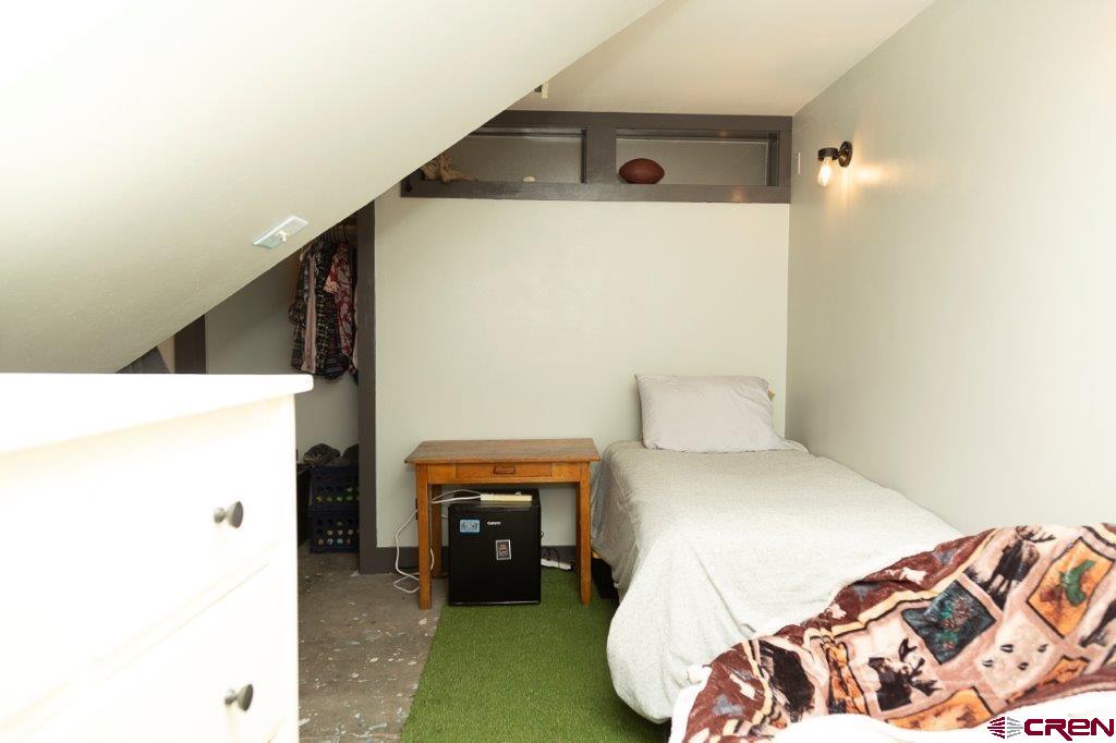 301 West 3rd Street Creede, CO 81130 - Photo 11 of 17 a bedroom with a bed and a fireplace