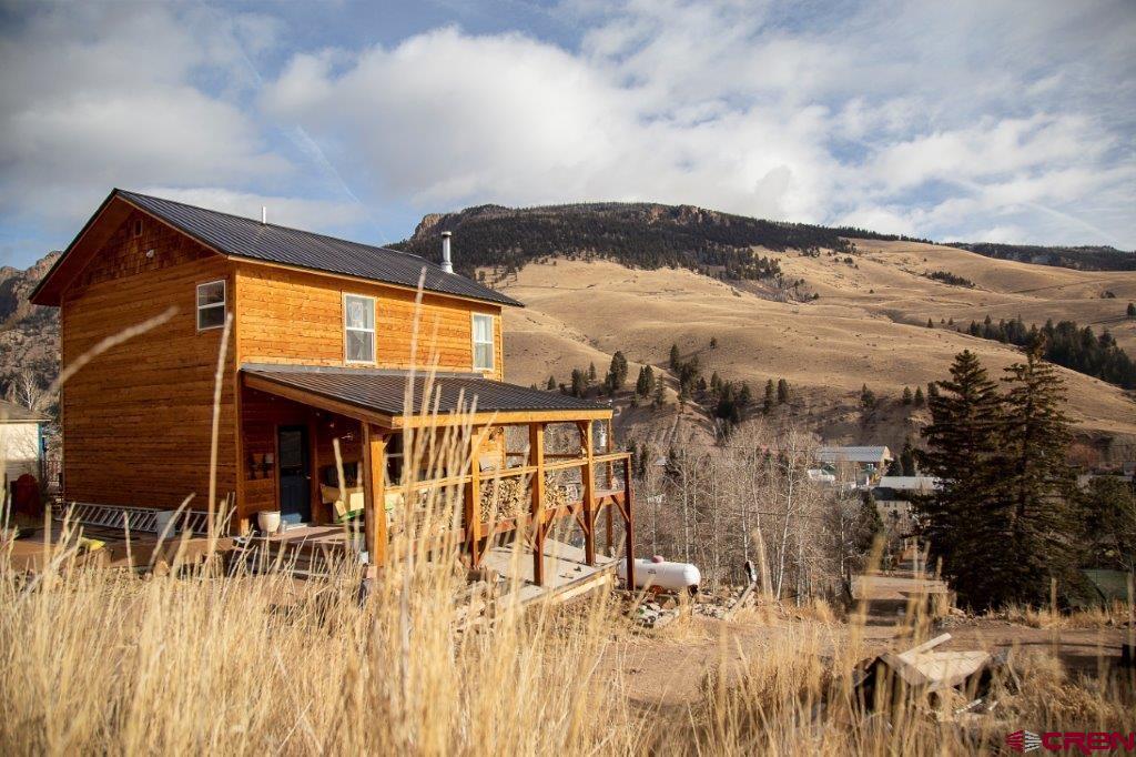 301 West 3rd Street Creede, CO 81130 - Photo 15 of 17 a view of a house with a backyard