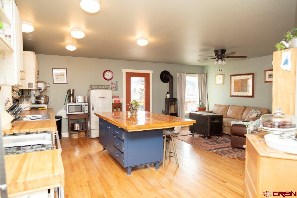 301 West 3rd Street Creede, CO 81130 - Photo 4 of 17 a living room with stainless steel appliances kitchen island granite countertop furniture and a kitchen view