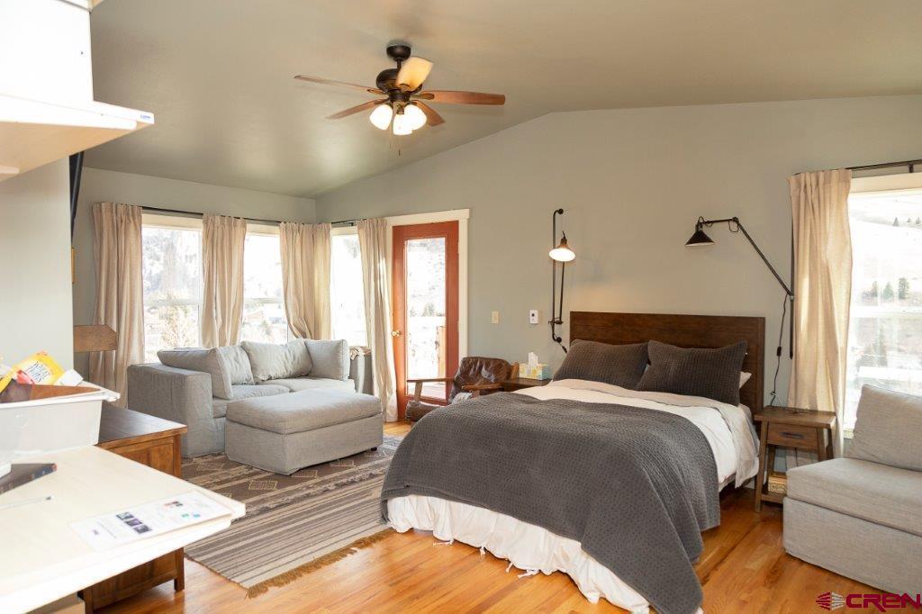 301 West 3rd Street Creede, CO 81130 - Photo 8 of 17 a spacious bedroom with two beds and a chandelier