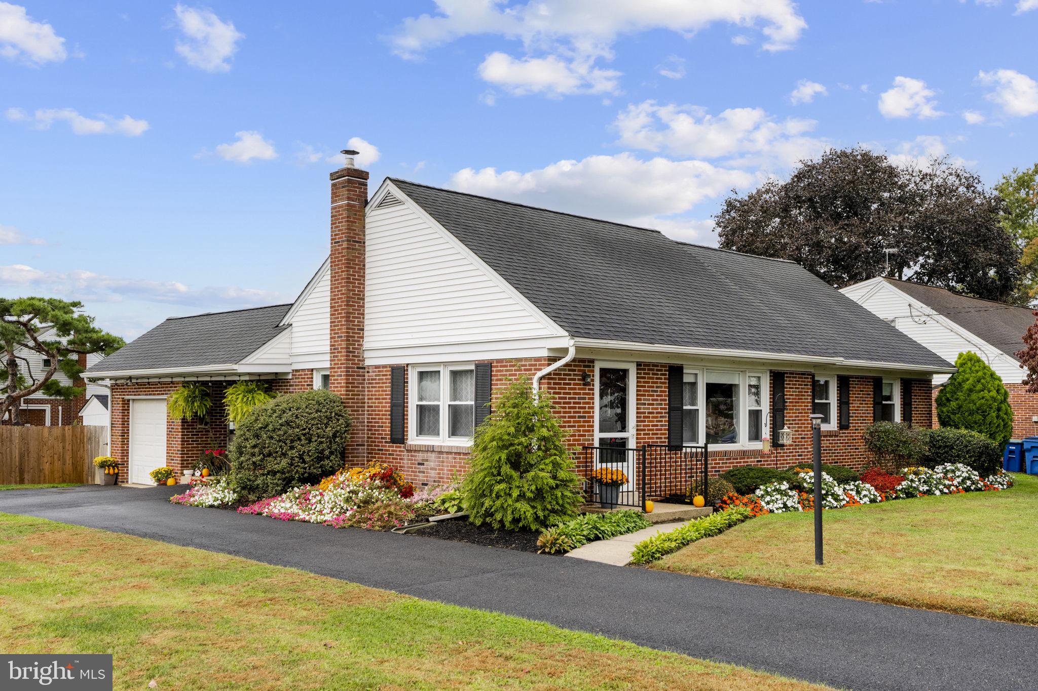 a view of a house with table and chairs in patio