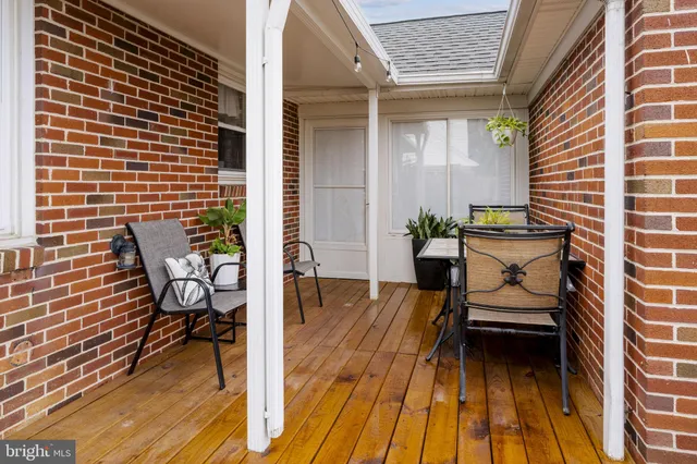 a view of a patio with a dining table and chairs