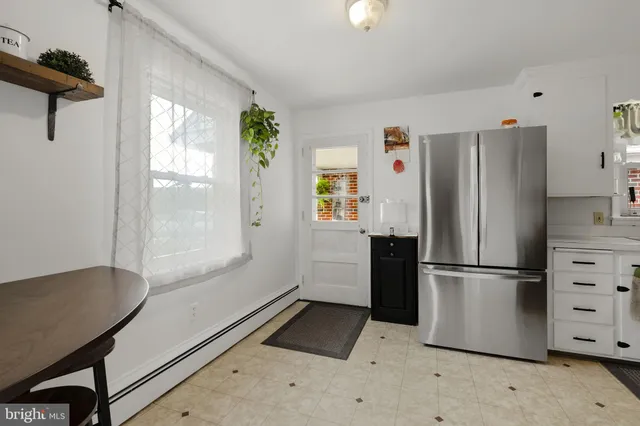 a kitchen with stainless steel appliances a refrigerator and a stove top oven
