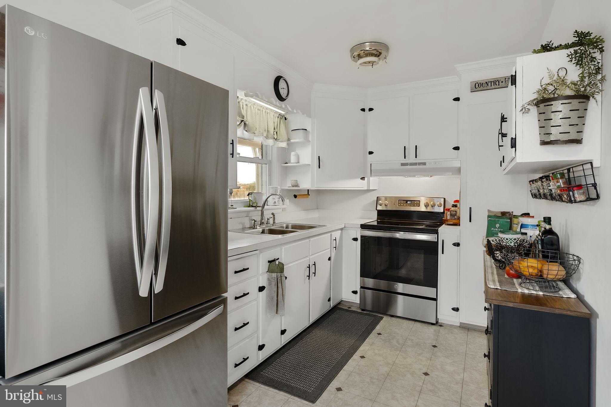 210 Musser Road East Earl, PA 17519 - Photo 22 of 44 a kitchen with stainless steel appliances a refrigerator sink and cabinets