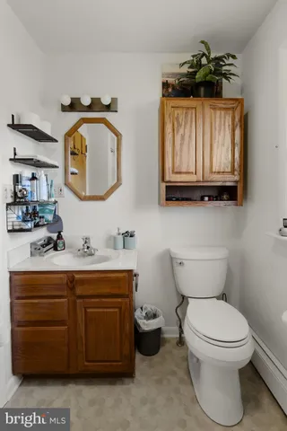a bathroom with a toilet a sink and a mirror