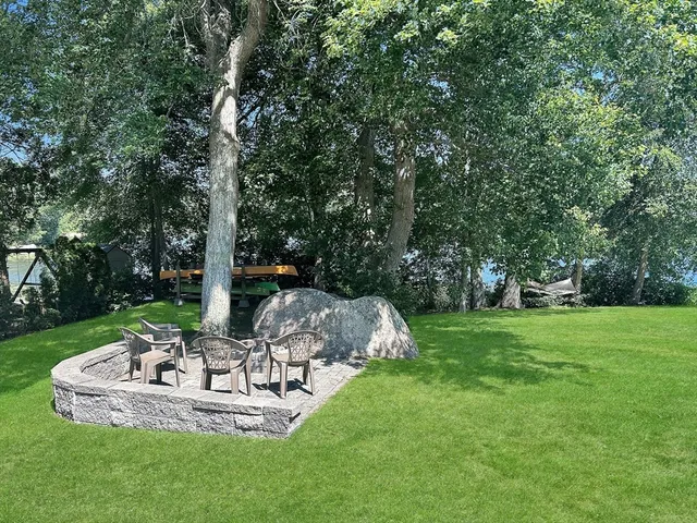a view of a table and chairs in the garden