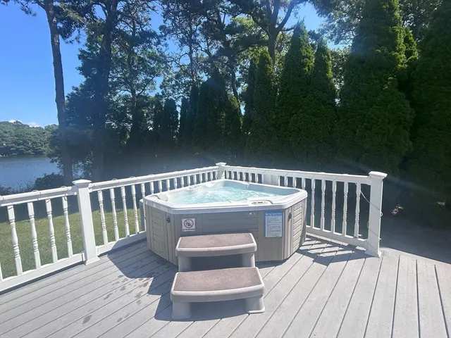 a living room with furniture a flat screen tv and a large window