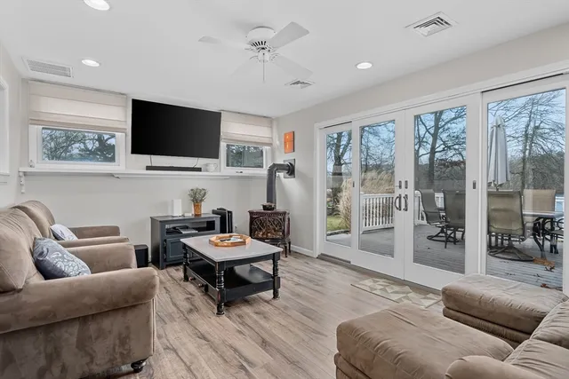 a living room with furniture and a floor to ceiling window
