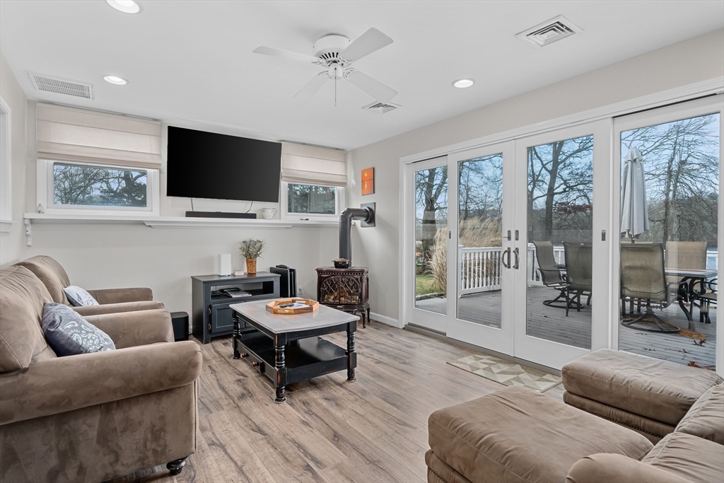 17 Maple Street Bourne, MA 02532 - Photo 13 of 33 a living room with furniture a flat screen tv and a large window