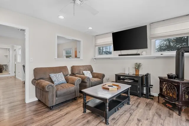 a kitchen with stainless steel appliances granite countertop a stove a refrigerator a kitchen island a dining table and chairs