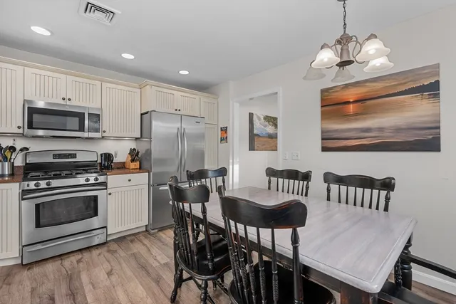 a kitchen with stainless steel appliances granite countertop a stove a sink a microwave and cabinets