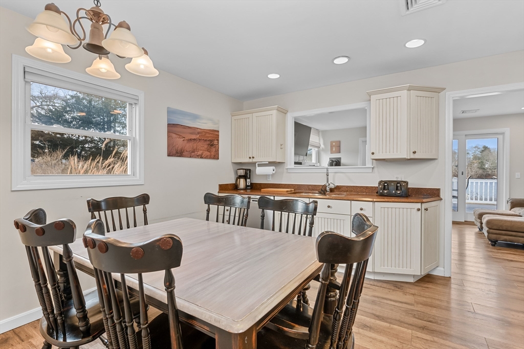 17 Maple Street Bourne, MA 02532 - Photo 18 of 33 a view of a dining room with furniture a chandelier and wooden floor