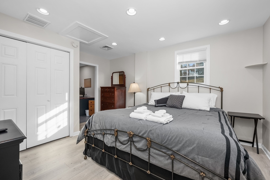 17 Maple Street Bourne, MA 02532 - Photo 19 of 33 a bedroom with a bed and wooden floor