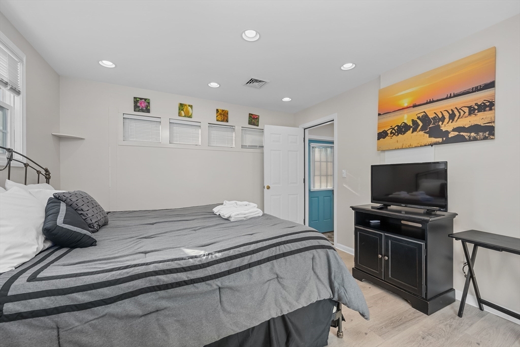 17 Maple Street Bourne, MA 02532 - Photo 20 of 33 a bedroom with a bed and a flat screen tv