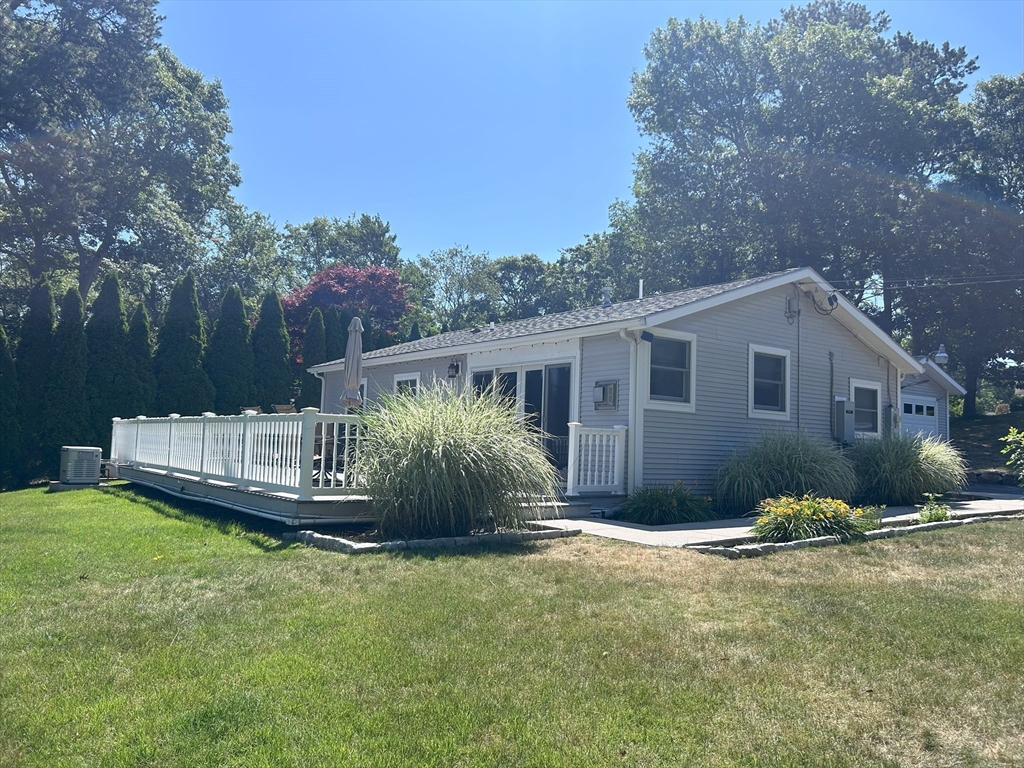 17 Maple Street Bourne, MA 02532 - Photo 2 of 33 a backyard of a house with table and chairs