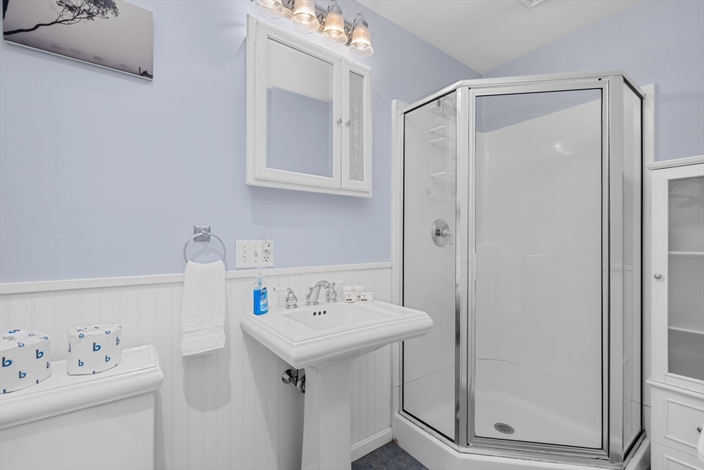 17 Maple Street Bourne, MA 02532 - Photo 21 of 33 a bathroom with a sink a mirror and a shower