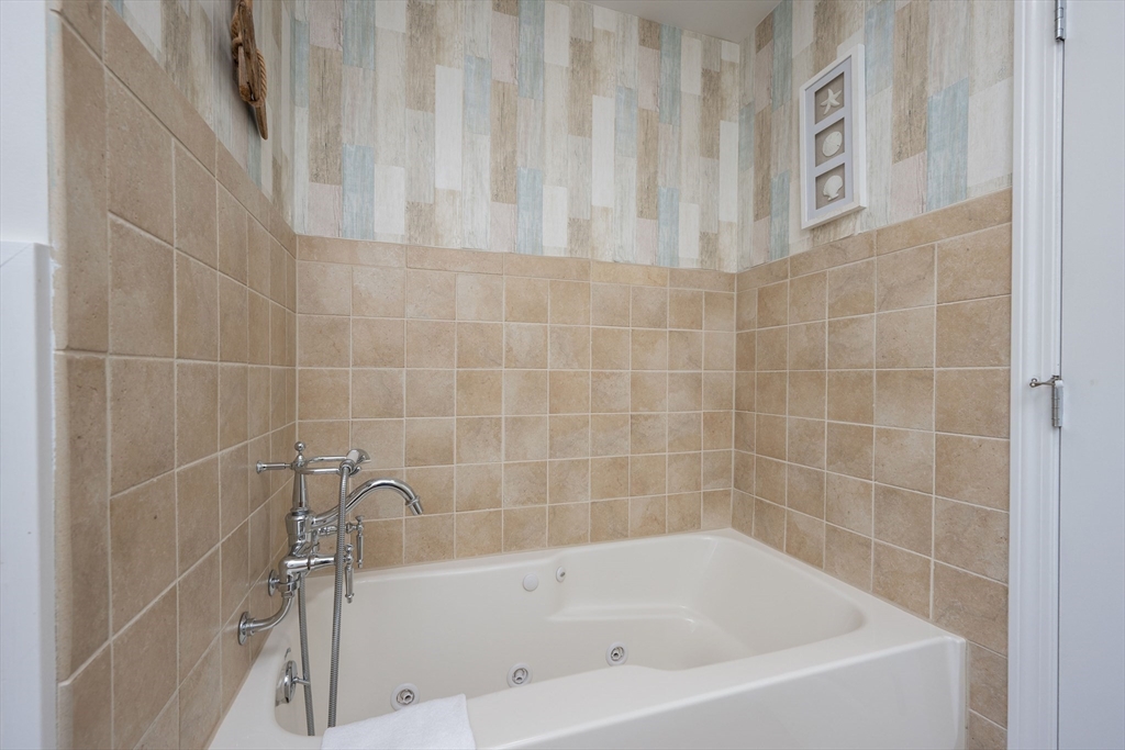 17 Maple Street Bourne, MA 02532 - Photo 28 of 33 a bath tub sitting next to a white sink