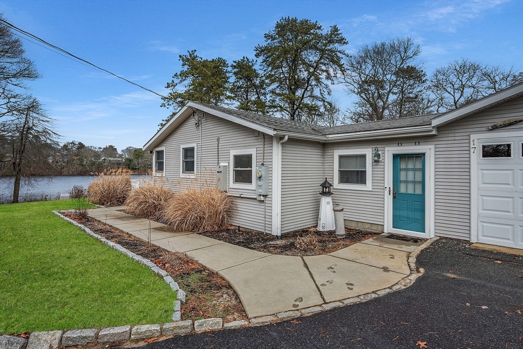 17 Maple Street Bourne, MA 02532 - Photo 3 of 33 a front view of a house with a yard