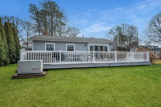a front view of house with yard and deck
