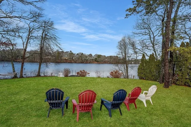 a backyard of a house with table and chairs