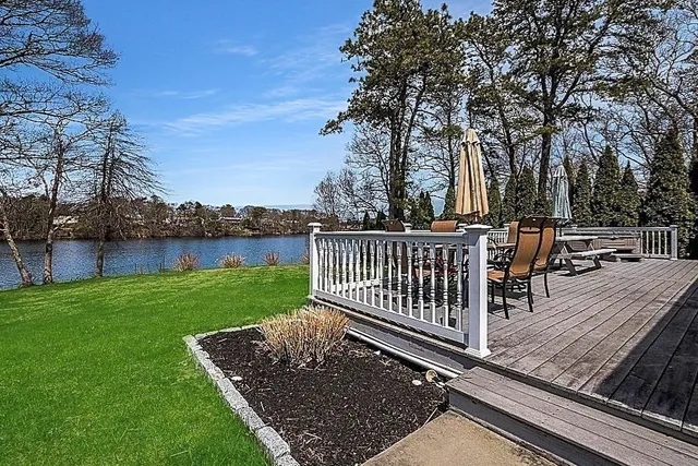 a view of a backyard with wooden deck