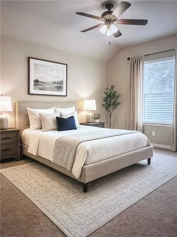 a view of an empty room with a ceiling fan