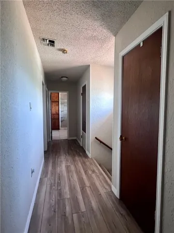 a view of wooden floor and windows in a room