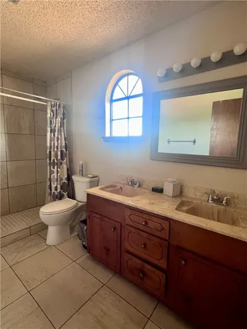 a room with wooden floor and chandelier fan