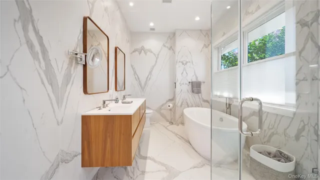a spacious bathroom with a double vanity sink and a mirror