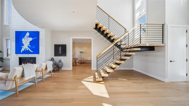 a view of entryway livingroom and hall with wooden floor