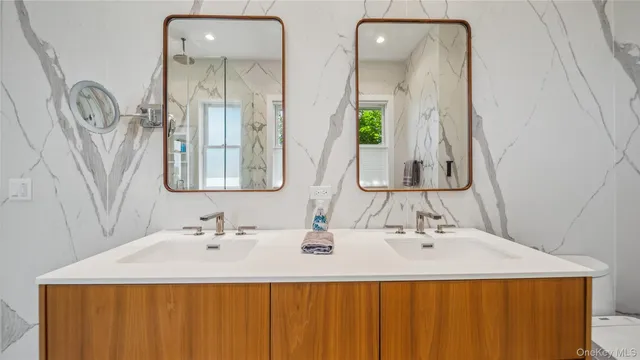 a bathroom with a double vanity sink and a mirror