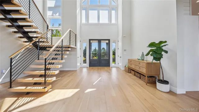 a living room with stairs and a wooden floor