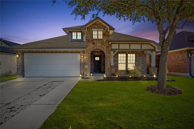 a front view of a house with a yard