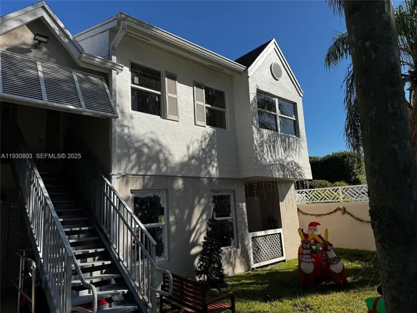 a front view of a house with stairs