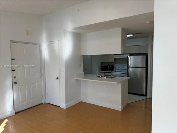 a kitchen with stainless steel appliances a refrigerator and a stove top oven