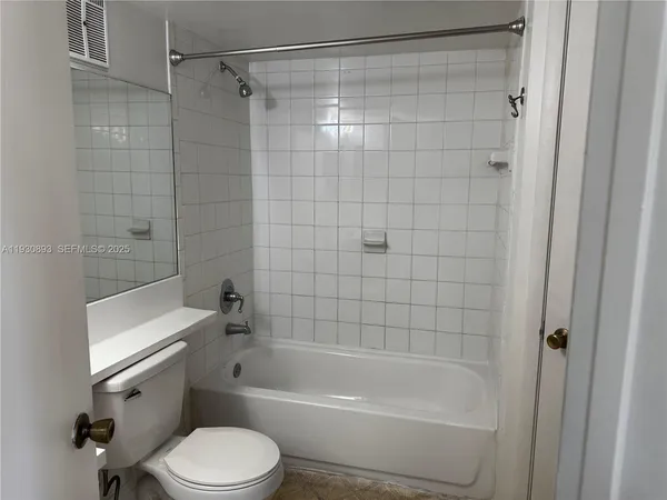 a bathroom with a toilet bathtub and shower