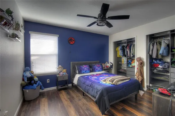 a bedroom with a bed and wooden floor