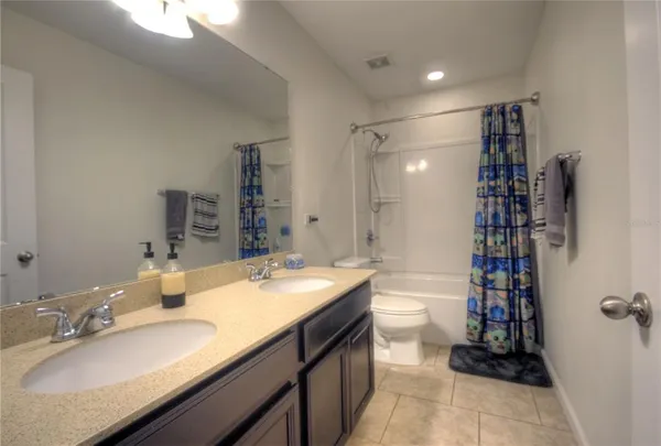 a bathroom with a sink double vanity and a shower