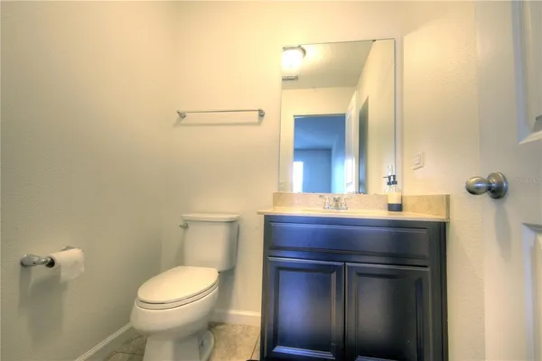 a bathroom with a sink a toilet and mirror