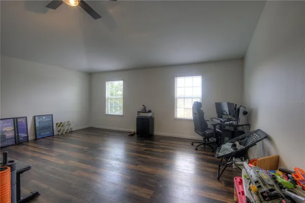 a view of a workspace with furniture and a window
