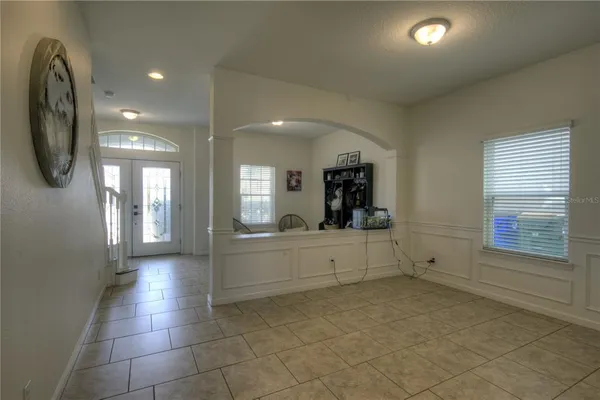 a large white kitchen with a large window