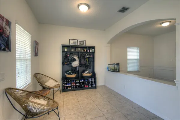 a living room with furniture a air conditioner vent and a window