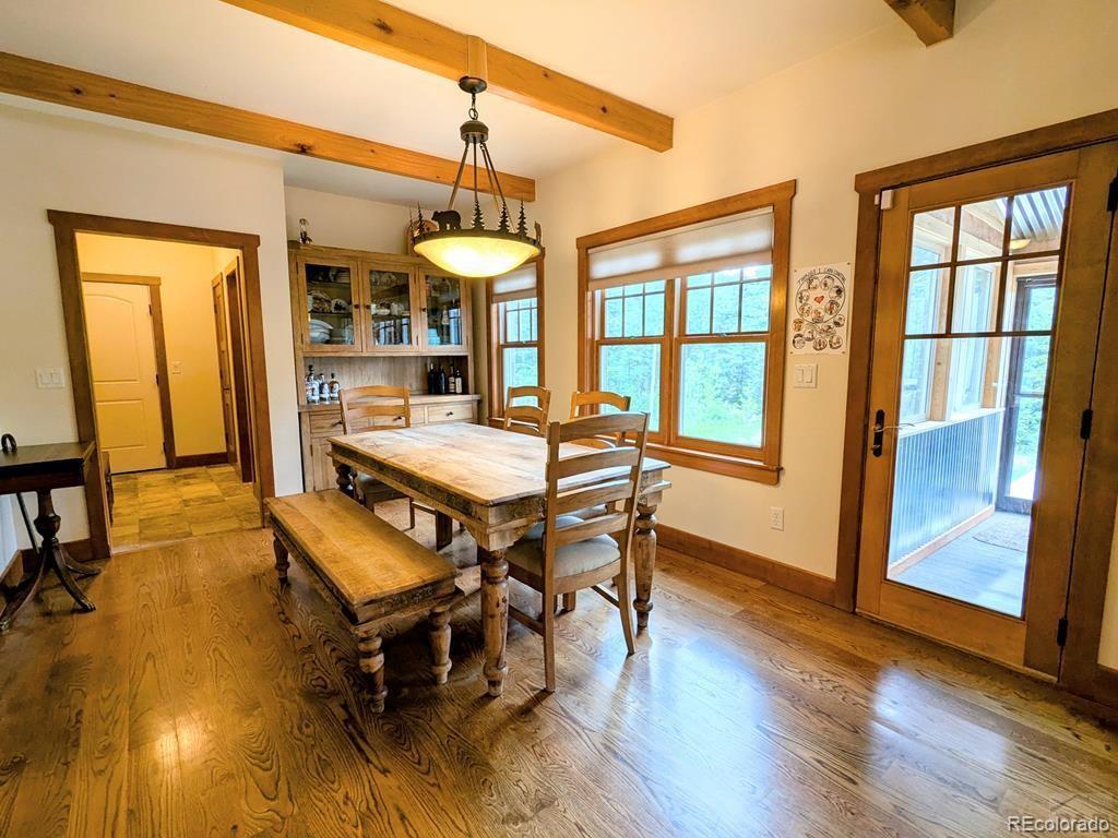 10 Robert Road Rye, CO 81069 - Photo 13 of 50 a dining room with wooden floor a chandelier a wooden table and chairs